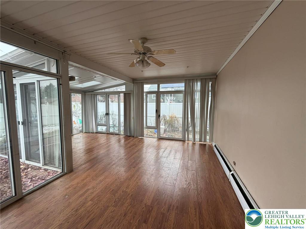 719 Hunter Street Catasauqua, PA 18032 - Photo 18 of 41 a view of an empty room with wooden floor and a window