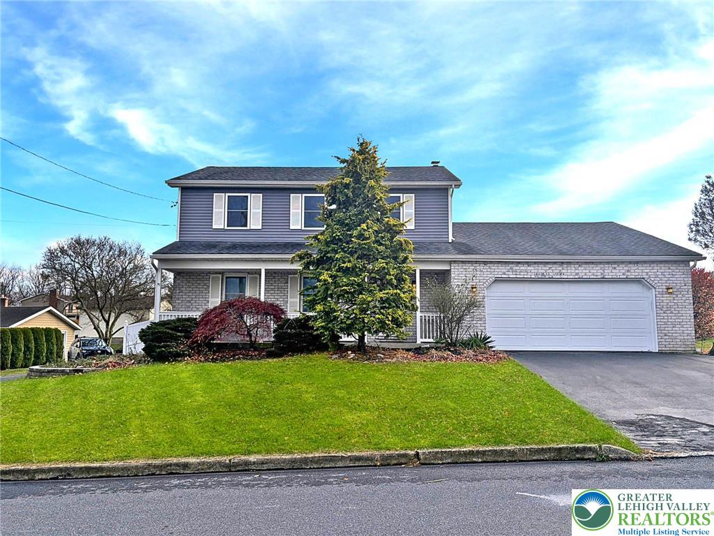 719 Hunter Street Catasauqua, PA 18032 - Photo 2 of 41 a front view of a house with a garden and plants