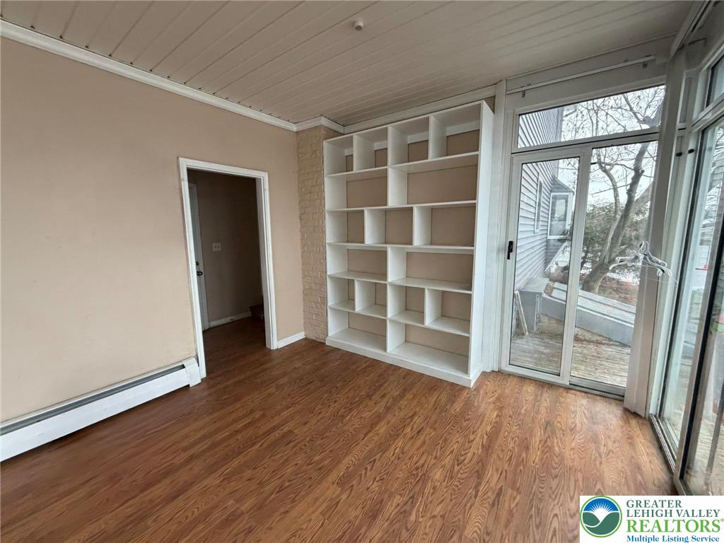719 Hunter Street Catasauqua, PA 18032 - Photo 23 of 41 an empty room with wooden floor and windows