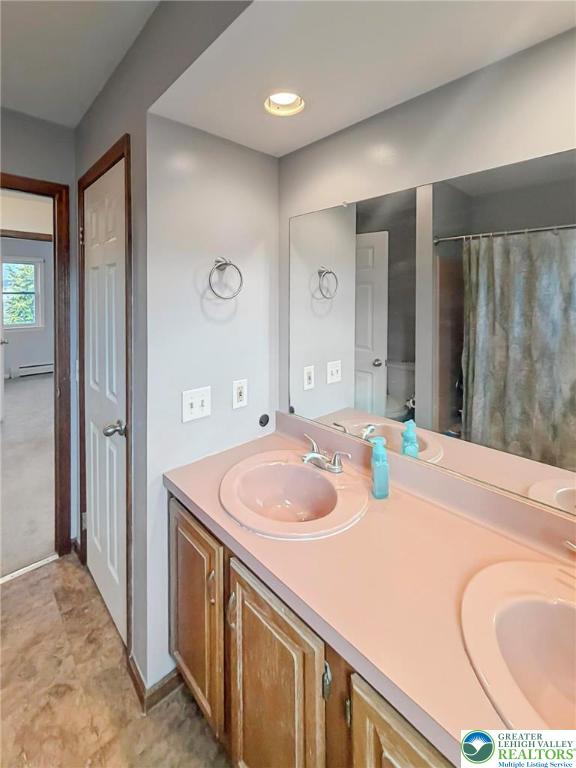 719 Hunter Street Catasauqua, PA 18032 - Photo 34 of 41 a bathroom with a sink a vanity and a mirror