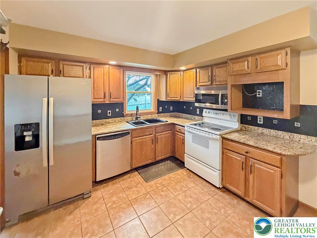 719 Hunter Street Catasauqua, PA 18032 - Photo 6 of 41 a kitchen with a sink stove and refrigerator