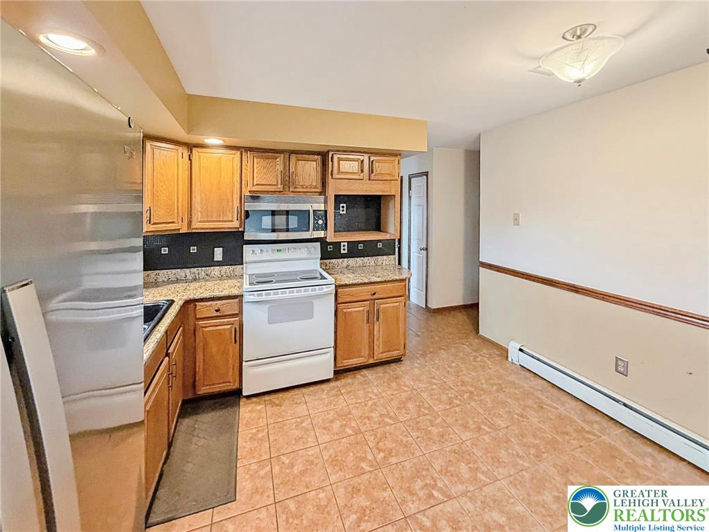 719 Hunter Street Catasauqua, PA 18032 - Photo 7 of 41 a kitchen with a stove top oven and cabinets