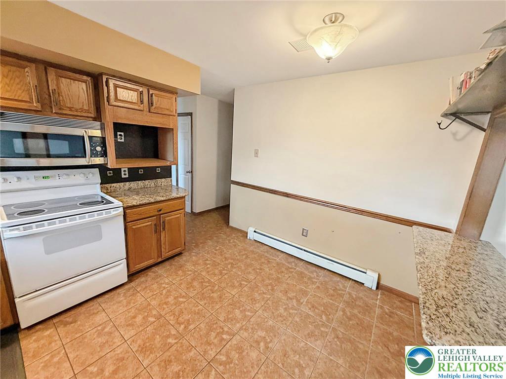 719 Hunter Street Catasauqua, PA 18032 - Photo 8 of 41 a kitchen with a stove top oven and cabinets