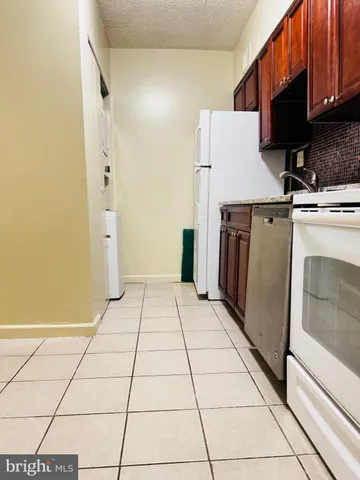 a kitchen with appliances cabinets and a counter top space
