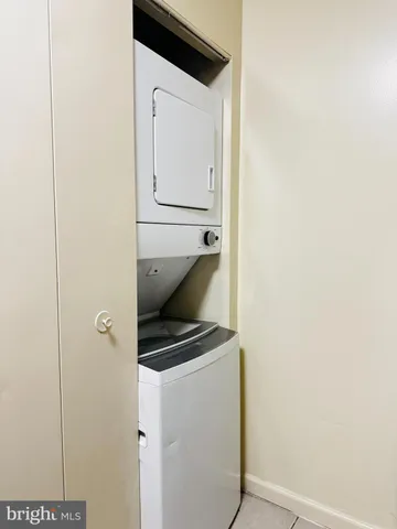 a view of a room with wooden floor and small window