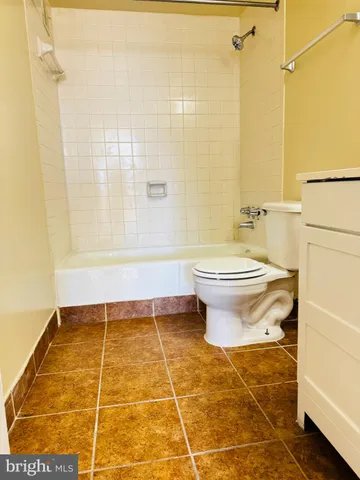 a bathroom with a sink a toilet and a shower