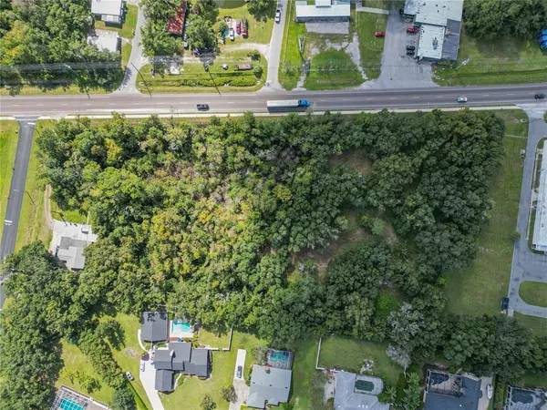 an aerial view of a house with a yard swimming pool and mountain view