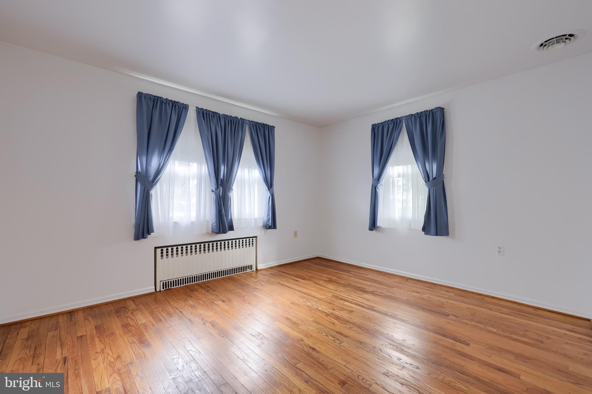 281 West Walnut Street Marietta, PA 17547 - Photo 14 of 17 an empty room with wooden floor cabinet and windows