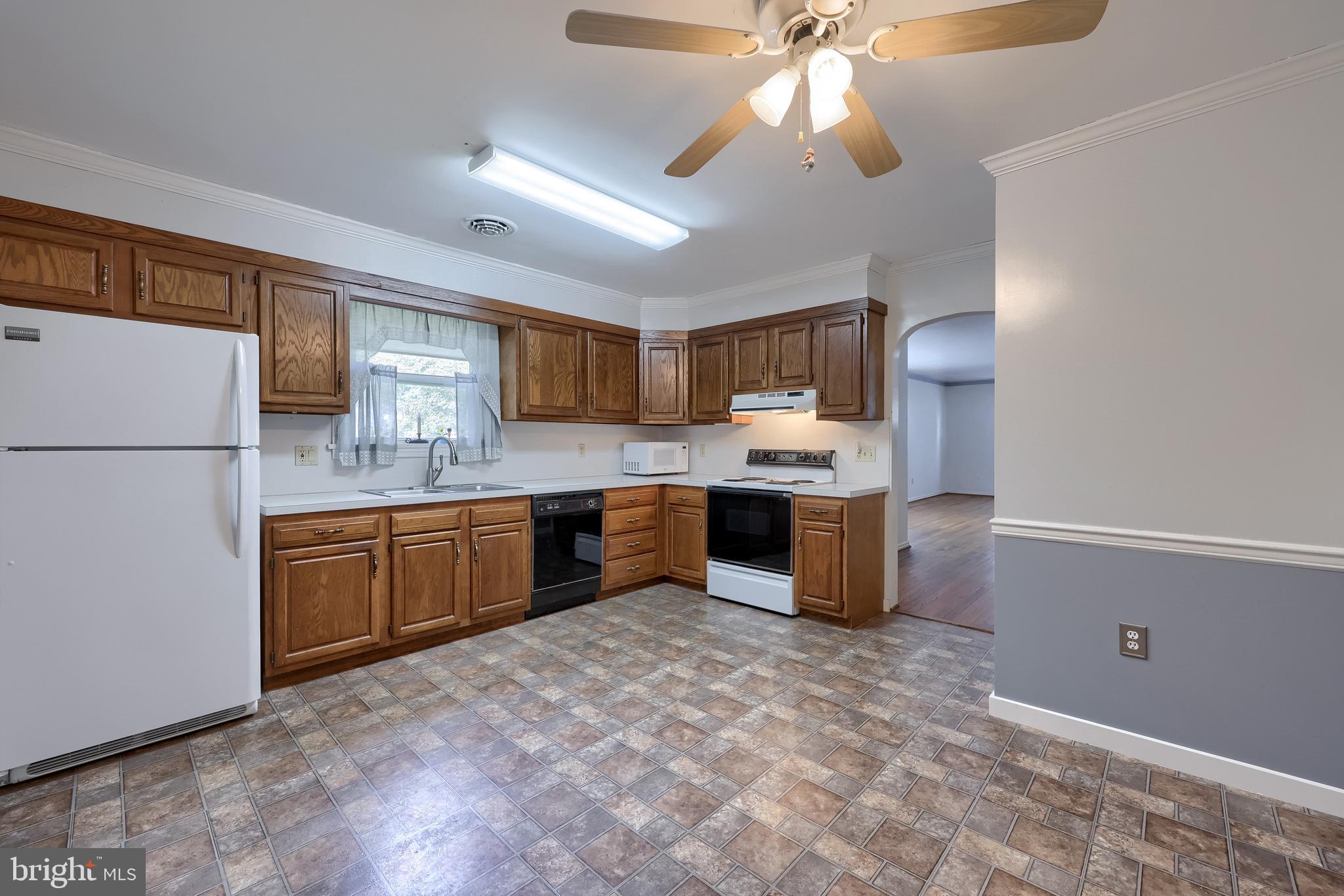 281 West Walnut Street Marietta, PA 17547 - Photo 4 of 17 a kitchen with stainless steel appliances granite countertop a refrigerator a sink dishwasher a stove with wooden cabinets and floor