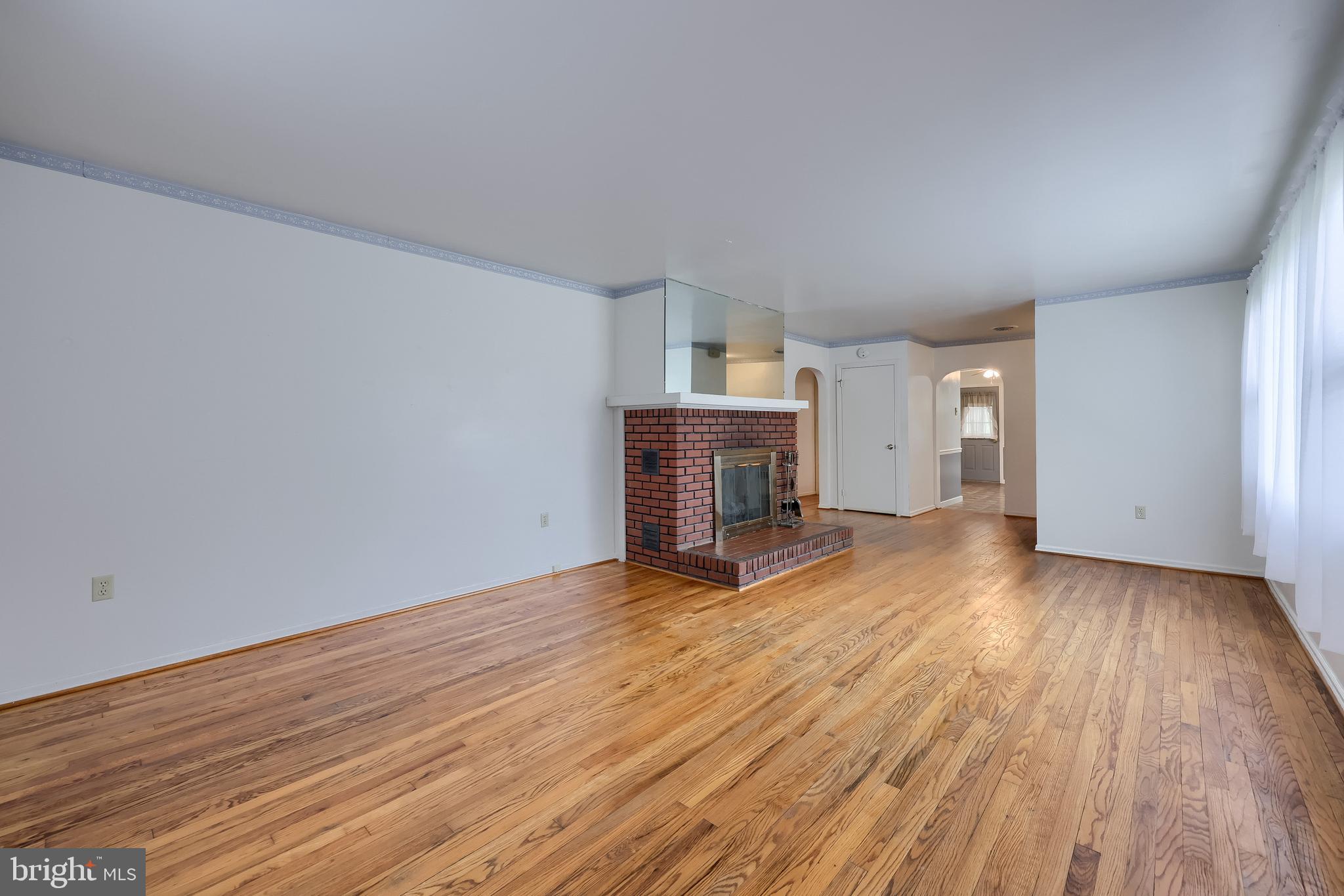 281 West Walnut Street Marietta, PA 17547 - Photo 8 of 17 a view of empty room with wooden floor and fireplace