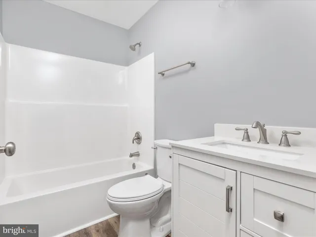 a bathroom with a sink a toilet and a bathtub