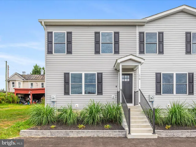 a view of a house with a small yard and plants