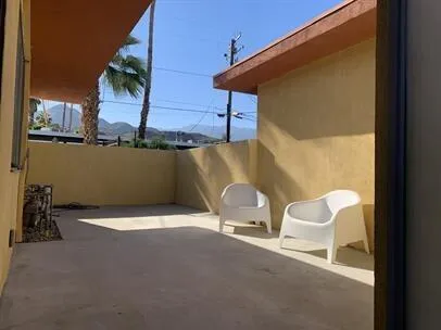 a balcony with table and chairs