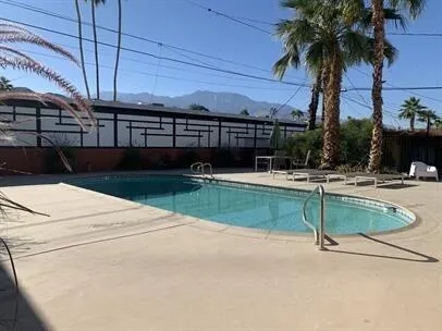 a view of swimming pool with outdoor seating