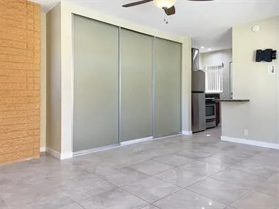 a view of an empty room with a kitchen