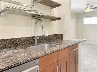a kitchen with a granite countertop sink