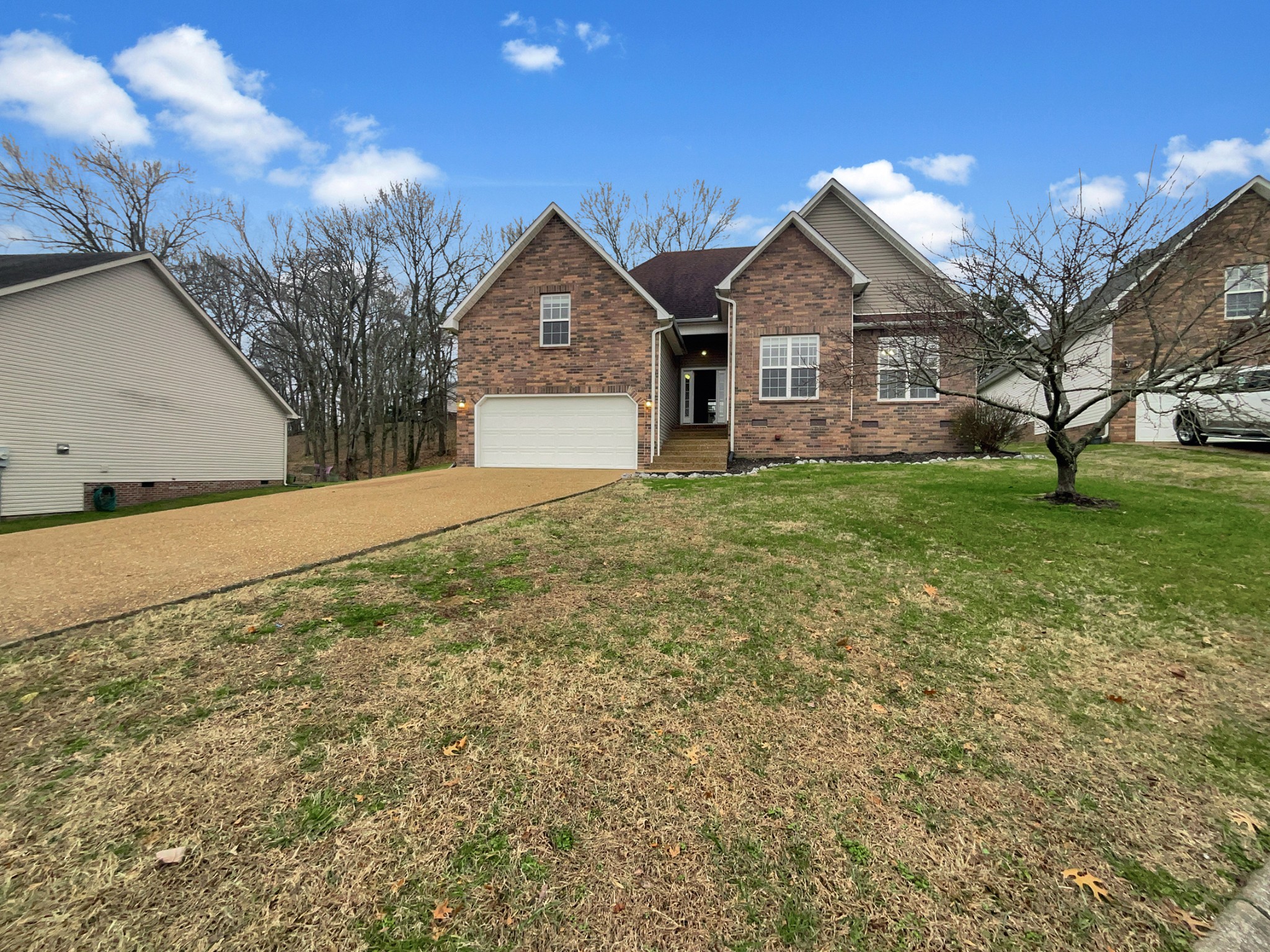 a front view of a house with a yard and garage