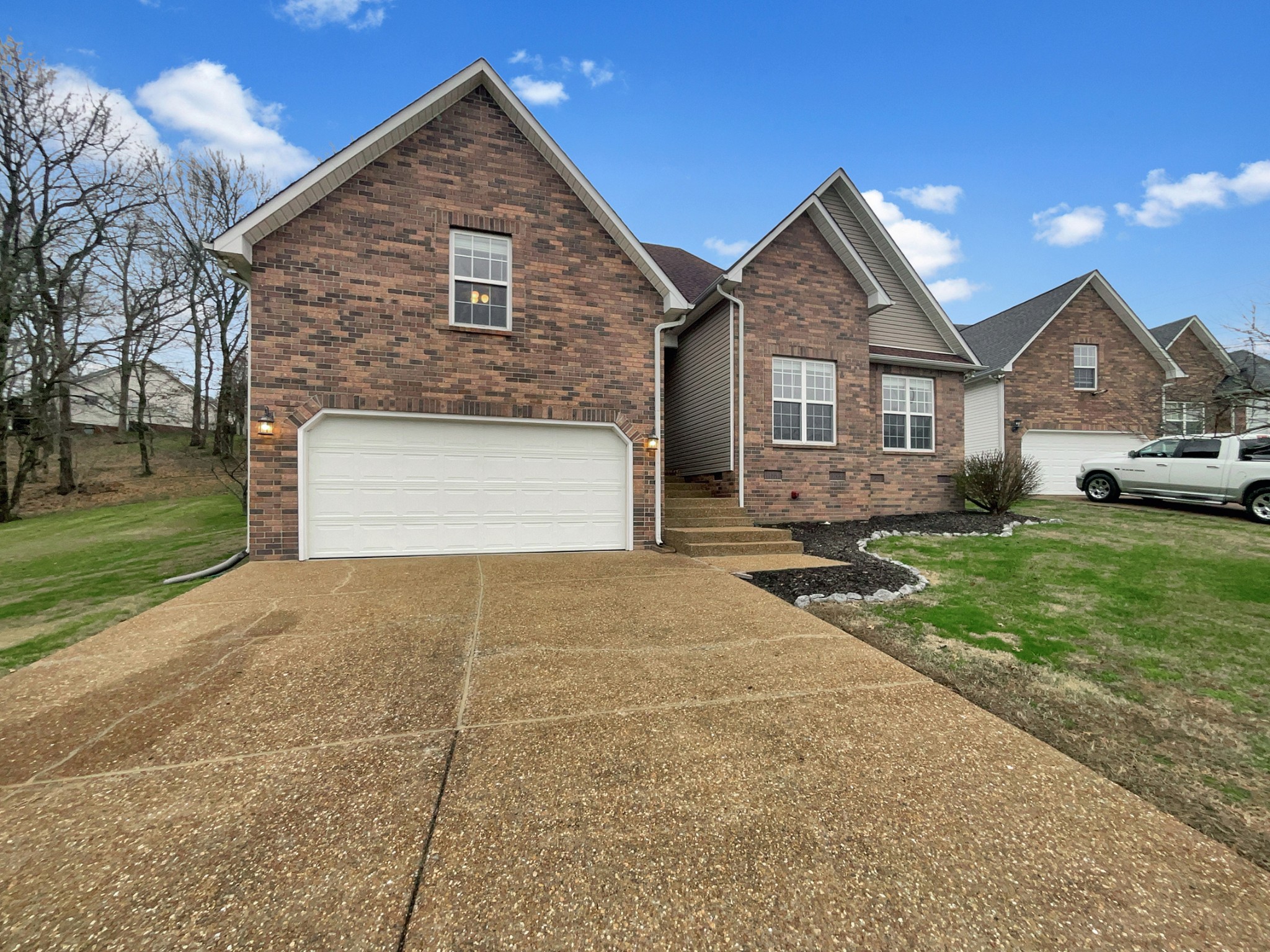 4022 Kristen Street Spring Hill, TN 37174 - Photo 2 of 23 a front view of a house with a yard and garage