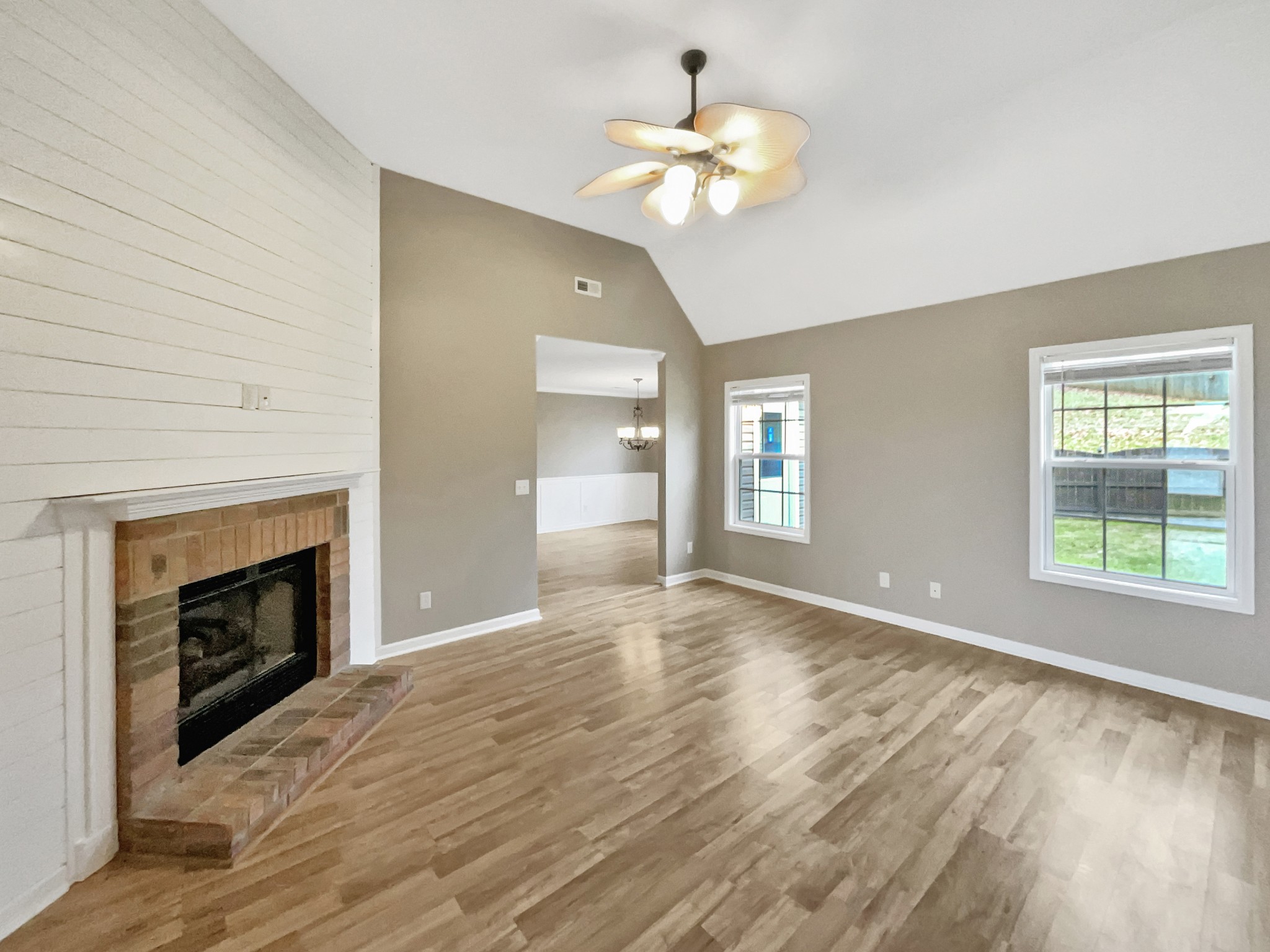 4022 Kristen Street Spring Hill, TN 37174 - Photo 4 of 23 an empty room with wooden floor fireplace and window