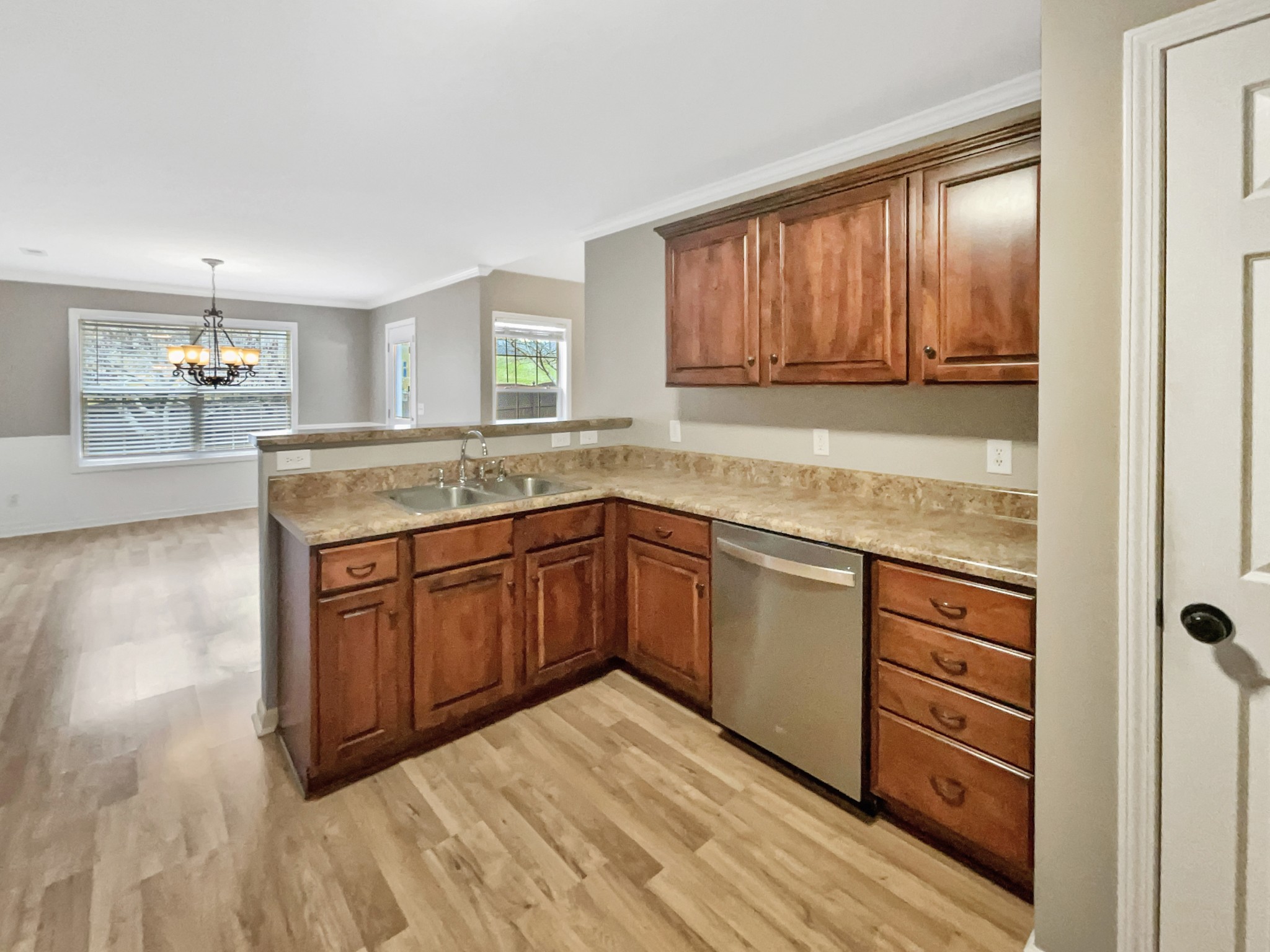 4022 Kristen Street Spring Hill, TN 37174 - Photo 10 of 23 a kitchen with stainless steel appliances granite countertop a sink and cabinets with wooden floor