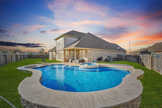 a view of a house with swimming pool and sitting area