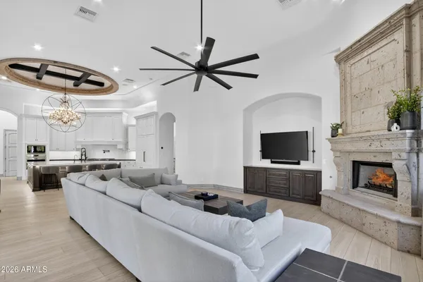 a hallway with white doors wooden floor and front door