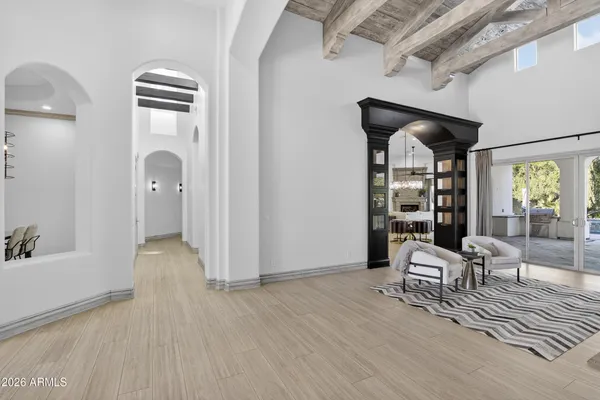 a kitchen with stainless steel appliances granite countertop a sink a microwave oven and a dining table with wooden floor