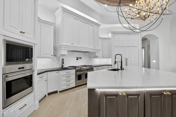 a kitchen with stainless steel appliances kitchen island a large counter top