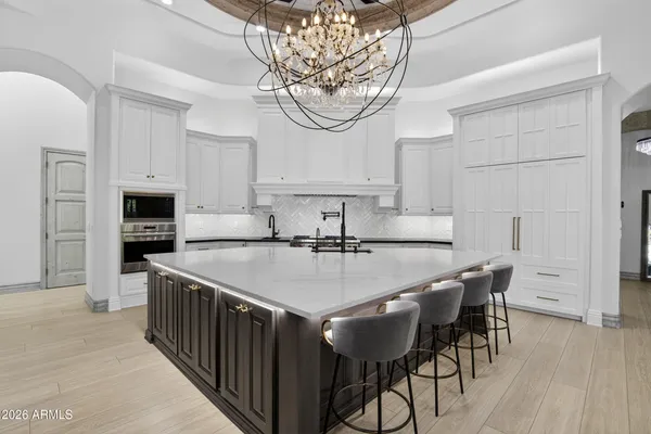 a view of a dining room with furniture and chandelier