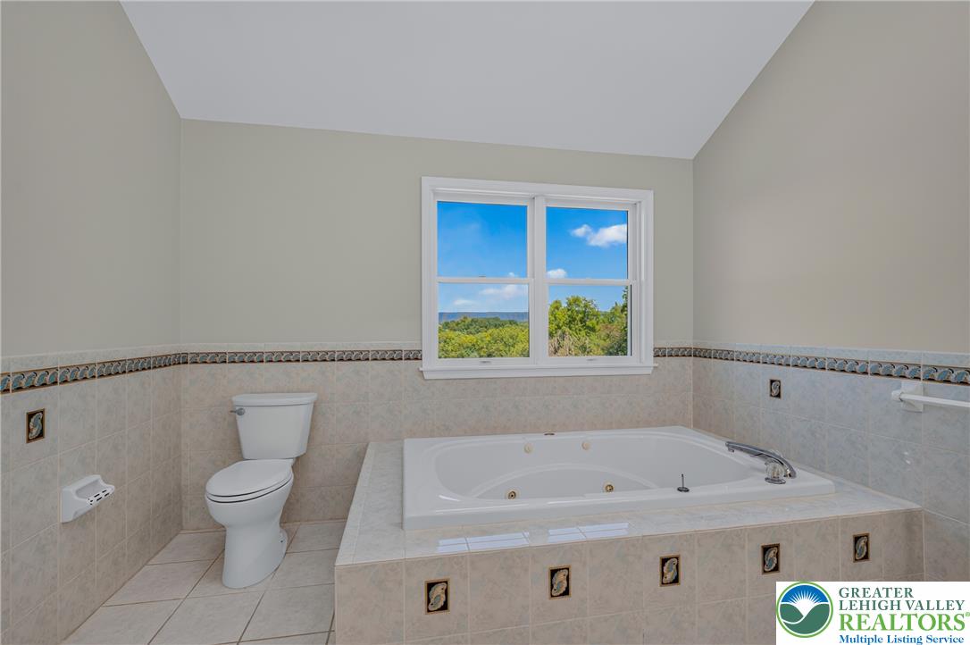 630 Clearfield Road Nazareth, PA 18064 - Photo 51 of 100 Vaulted ceilings and a deep soaking tub highlight this relaxing bathroom space.