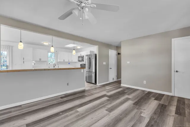 a kitchen with refrigerator and microwave