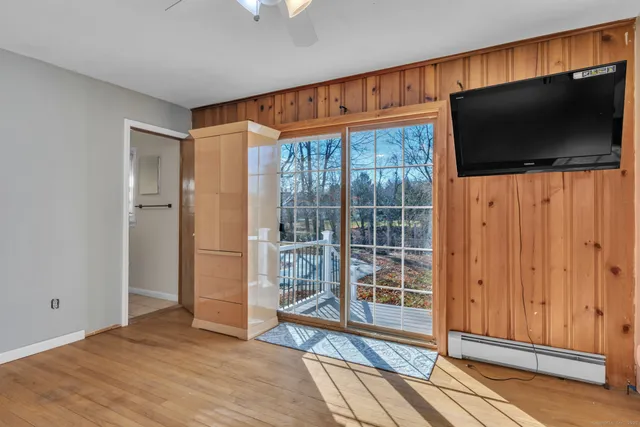 a view of empty room with wooden floor