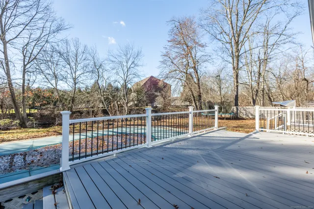 a view of a balcony with wooden floor and fence