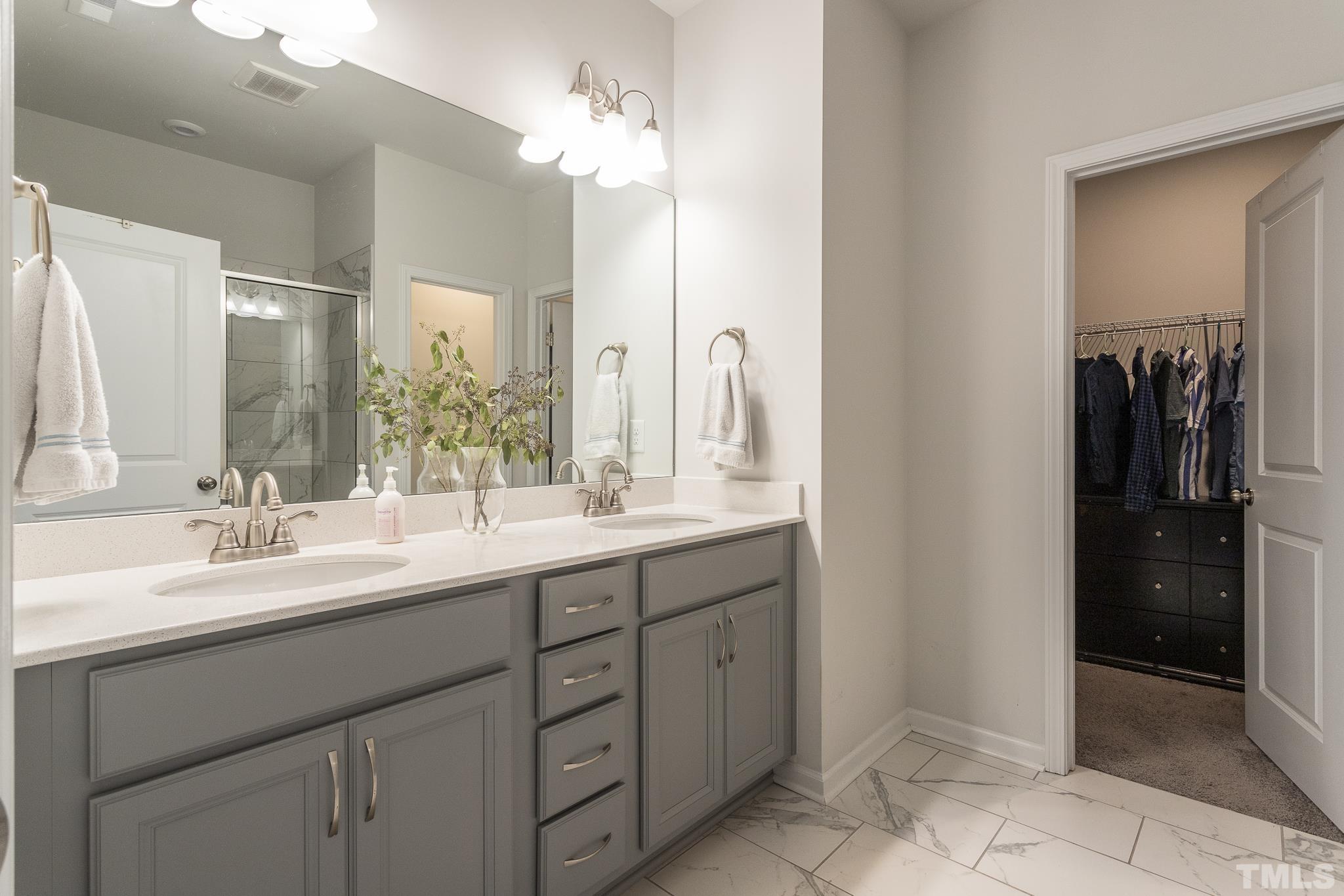 3700 Buffaloe Road Raleigh, NC 27604 - Photo 19 of 30 a bathroom with a double vanity sink a and a mirror