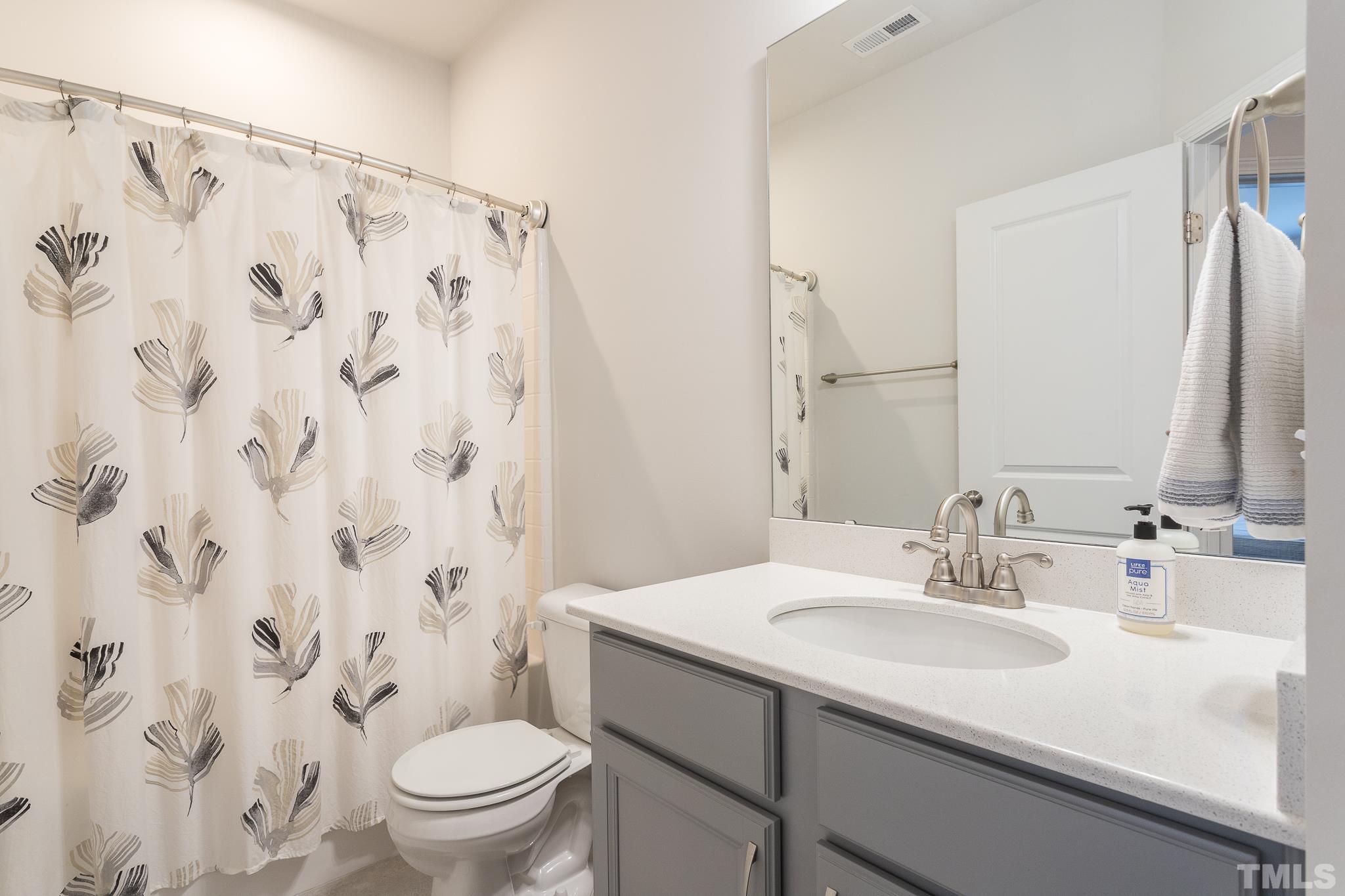3700 Buffaloe Road Raleigh, NC 27604 - Photo 25 of 30 a bathroom with a sink and a mirror