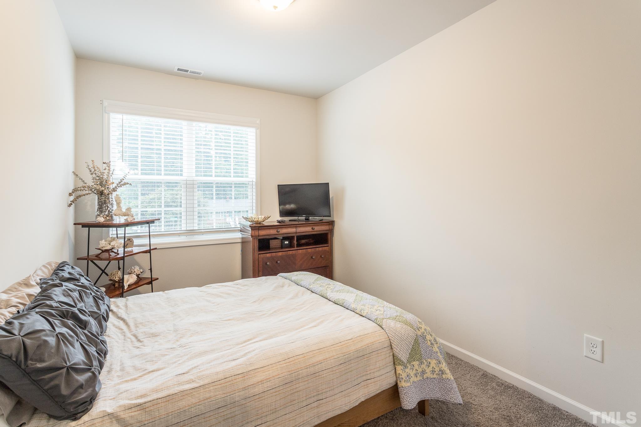 3700 Buffaloe Road Raleigh, NC 27604 - Photo 26 of 30 a bedroom with a bed and a large window