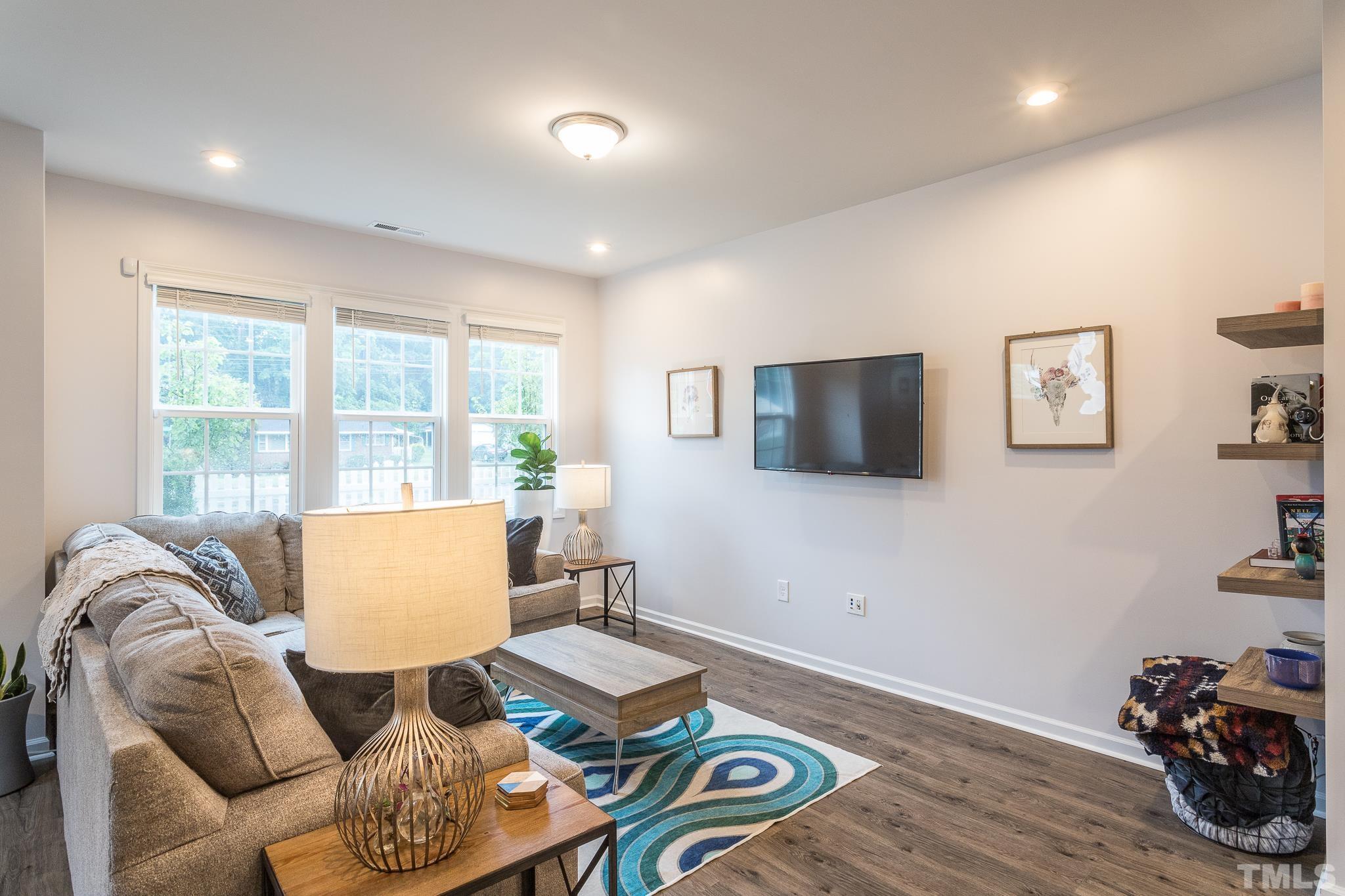 3700 Buffaloe Road Raleigh, NC 27604 - Photo 5 of 30 a living room with furniture and a flat screen tv