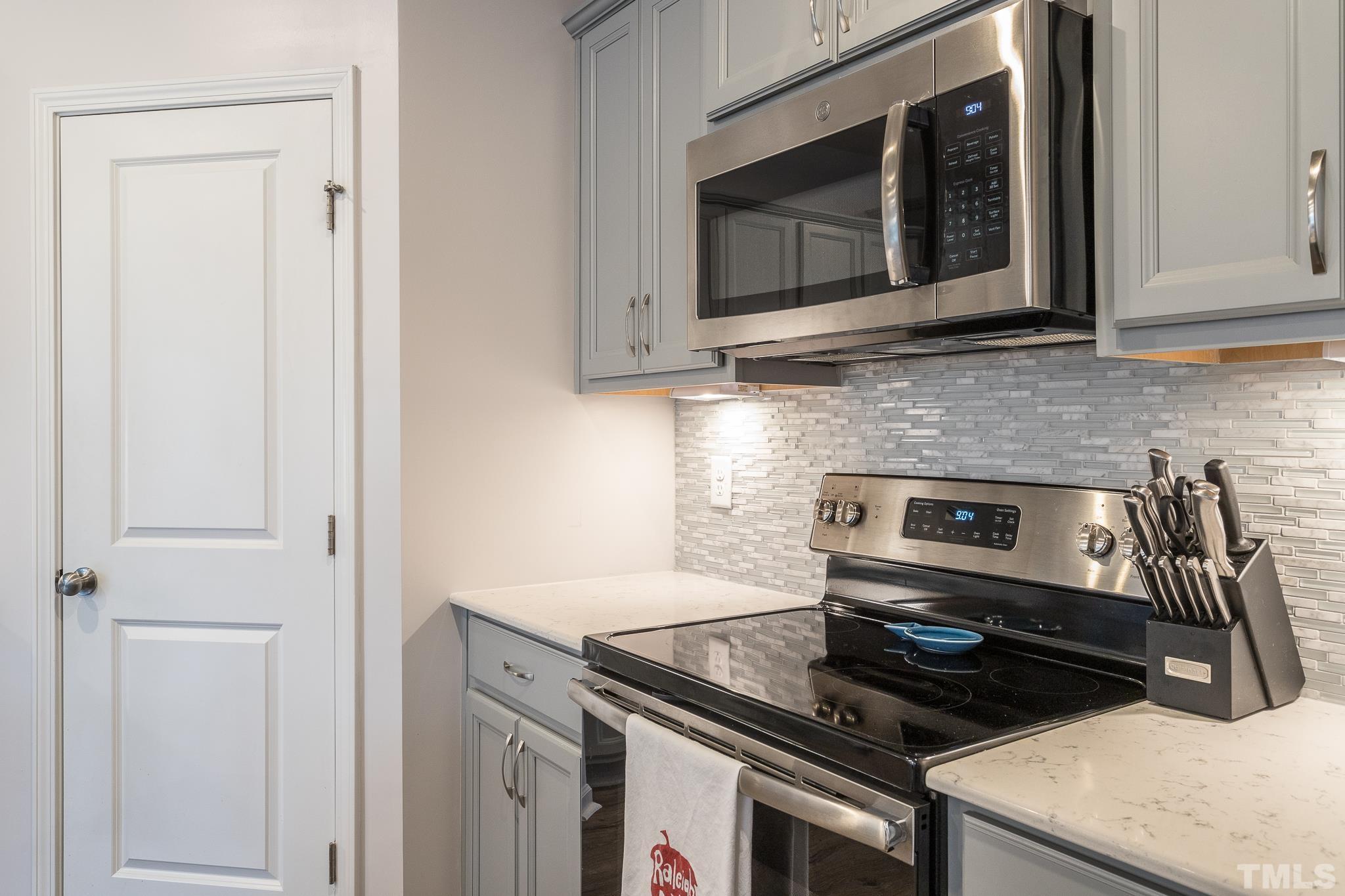 3700 Buffaloe Road Raleigh, NC 27604 - Photo 10 of 30 a kitchen with stainless steel appliances granite countertop white cabinets and black stove top oven with granite countertops