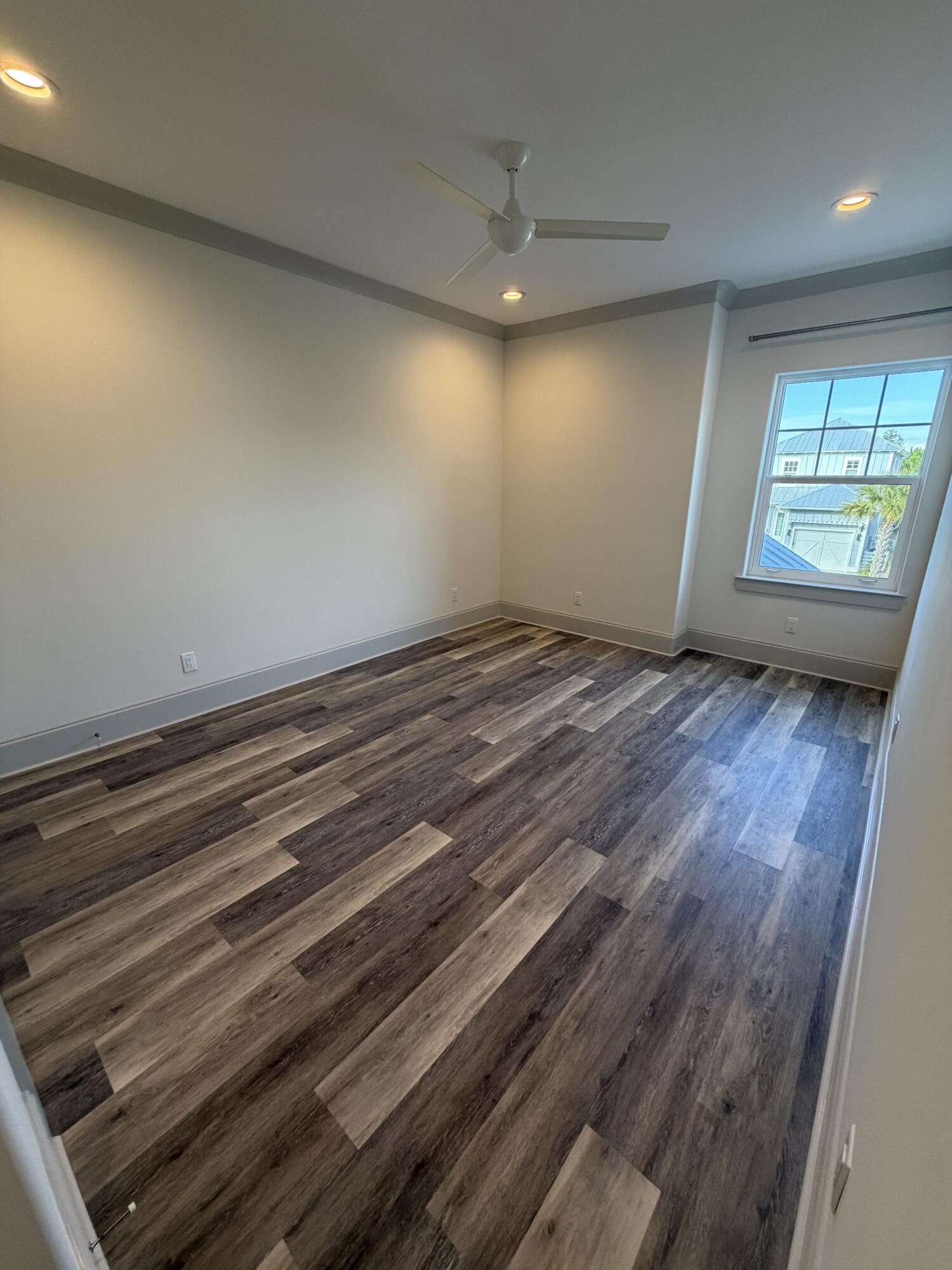 67 Heron's Crossing Santa Rosa Beach, FL 32459 - Photo 13 of 16 an empty room with wooden floor and windows