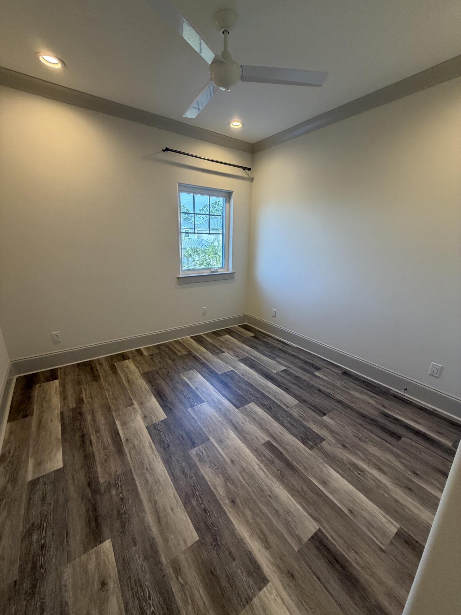 67 Heron's Crossing Santa Rosa Beach, FL 32459 - Photo 14 of 16 an empty room with wooden floor and windows