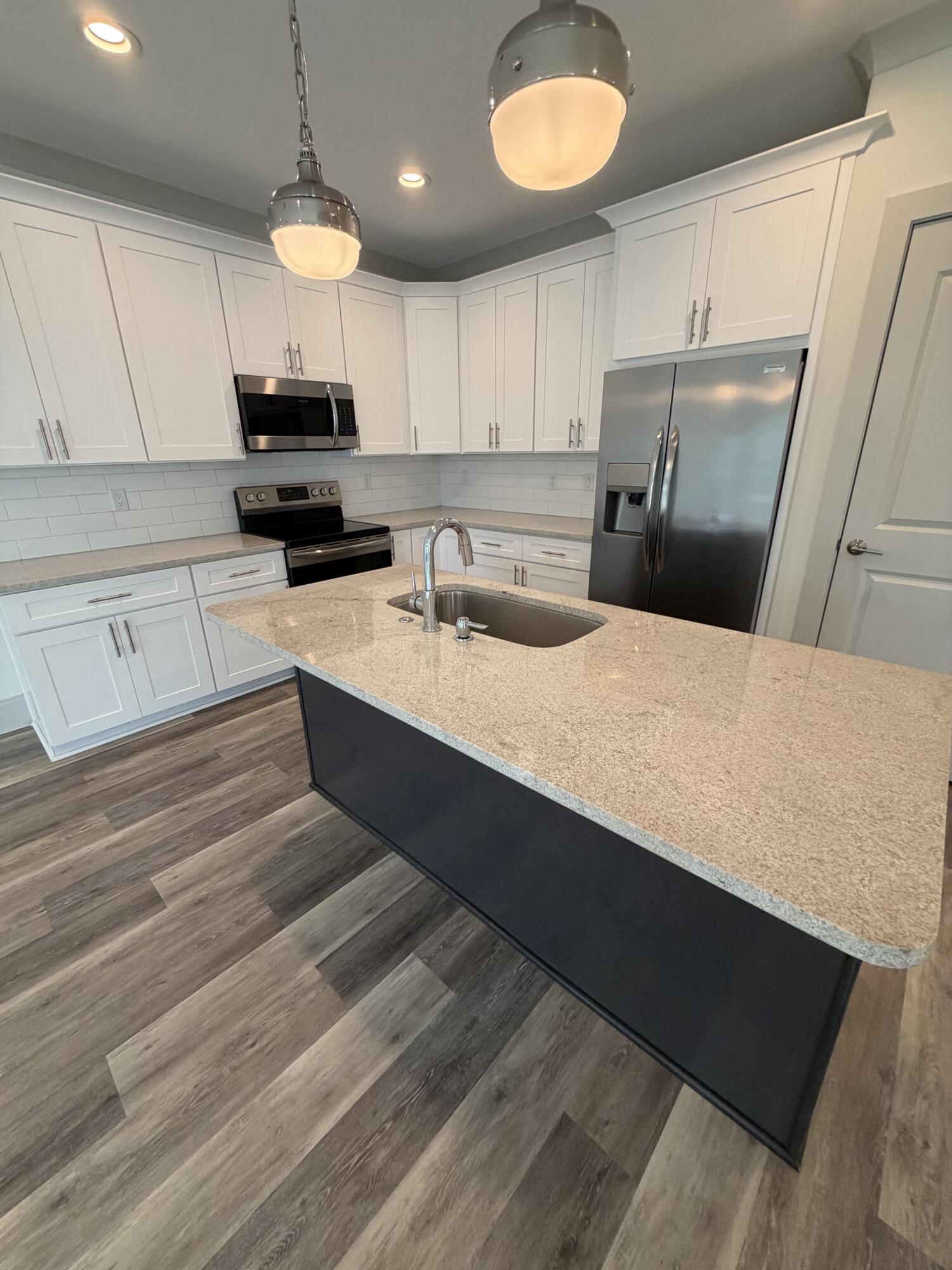 67 Heron's Crossing Santa Rosa Beach, FL 32459 - Photo 5 of 16 a kitchen with stainless steel appliances a refrigerator sink and cabinets