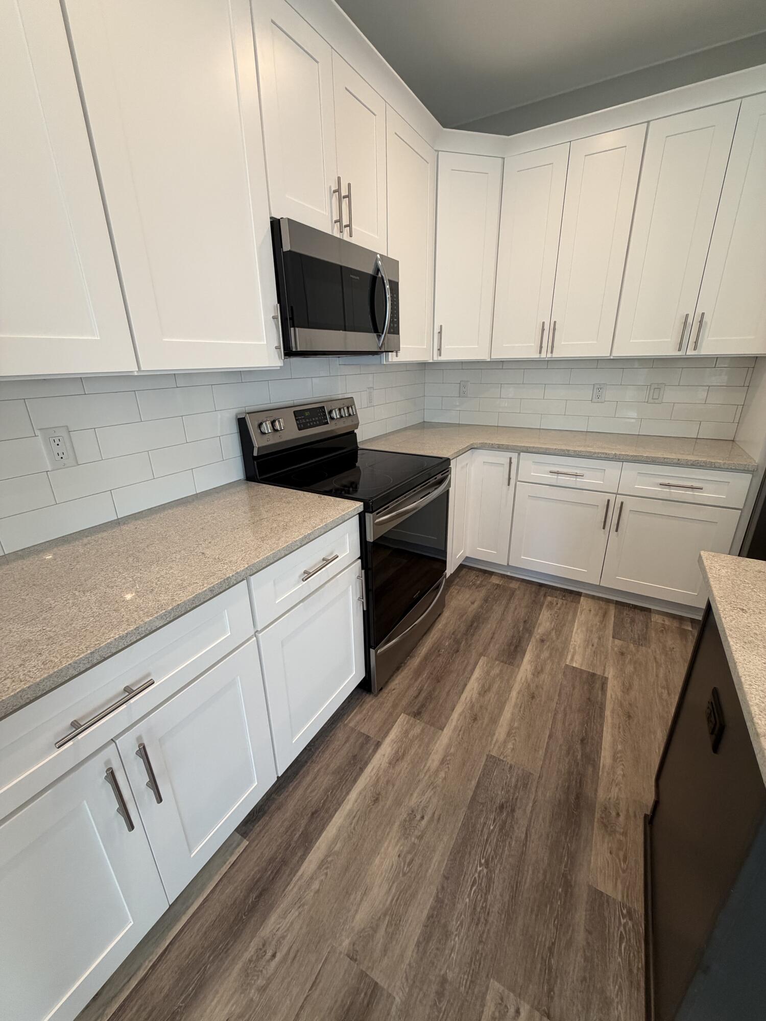67 Heron's Crossing Santa Rosa Beach, FL 32459 - Photo 6 of 16 a kitchen with a sink a microwave and cabinets