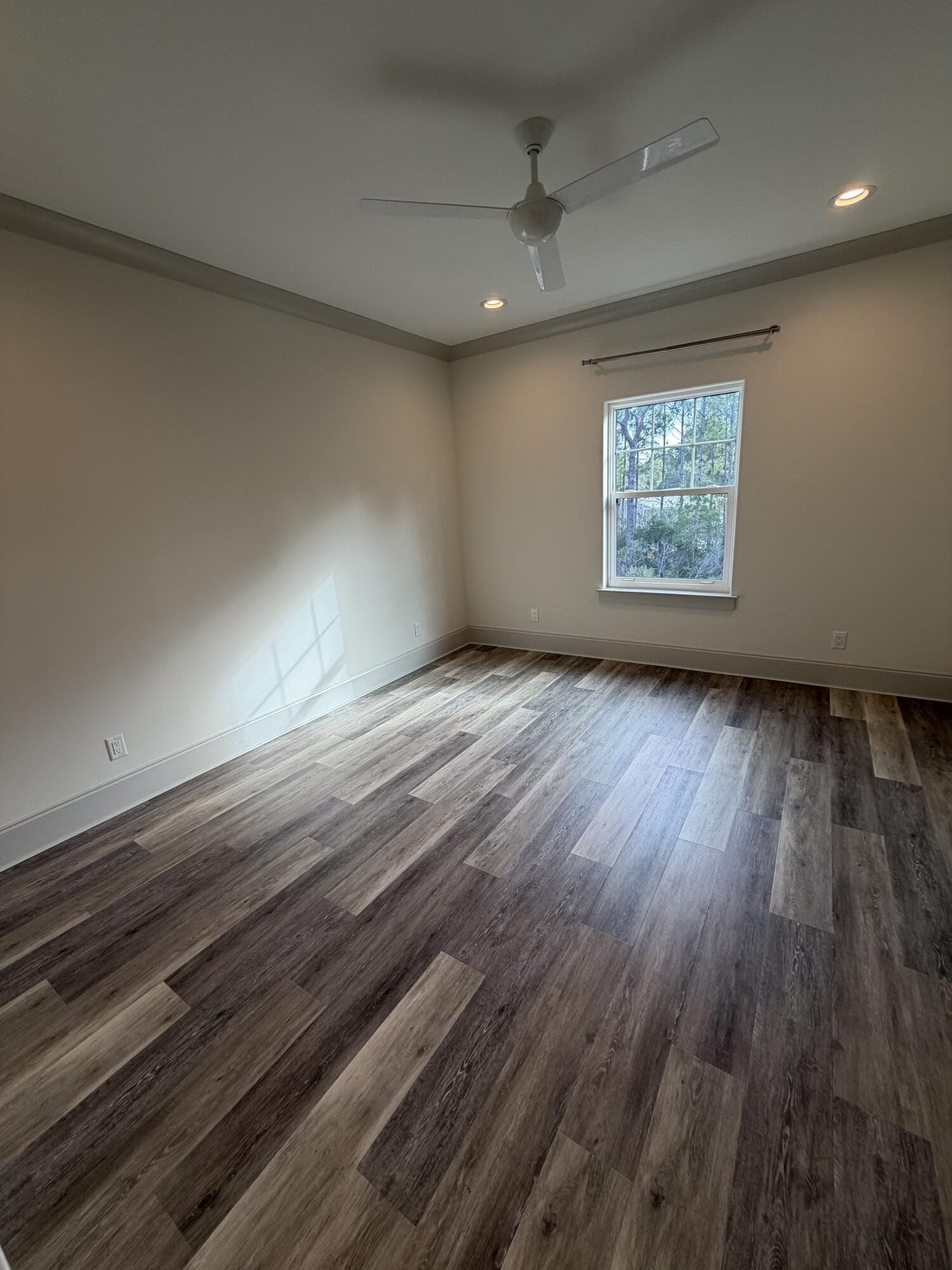 67 Heron's Crossing Santa Rosa Beach, FL 32459 - Photo 7 of 16 an empty room with wooden floor and windows