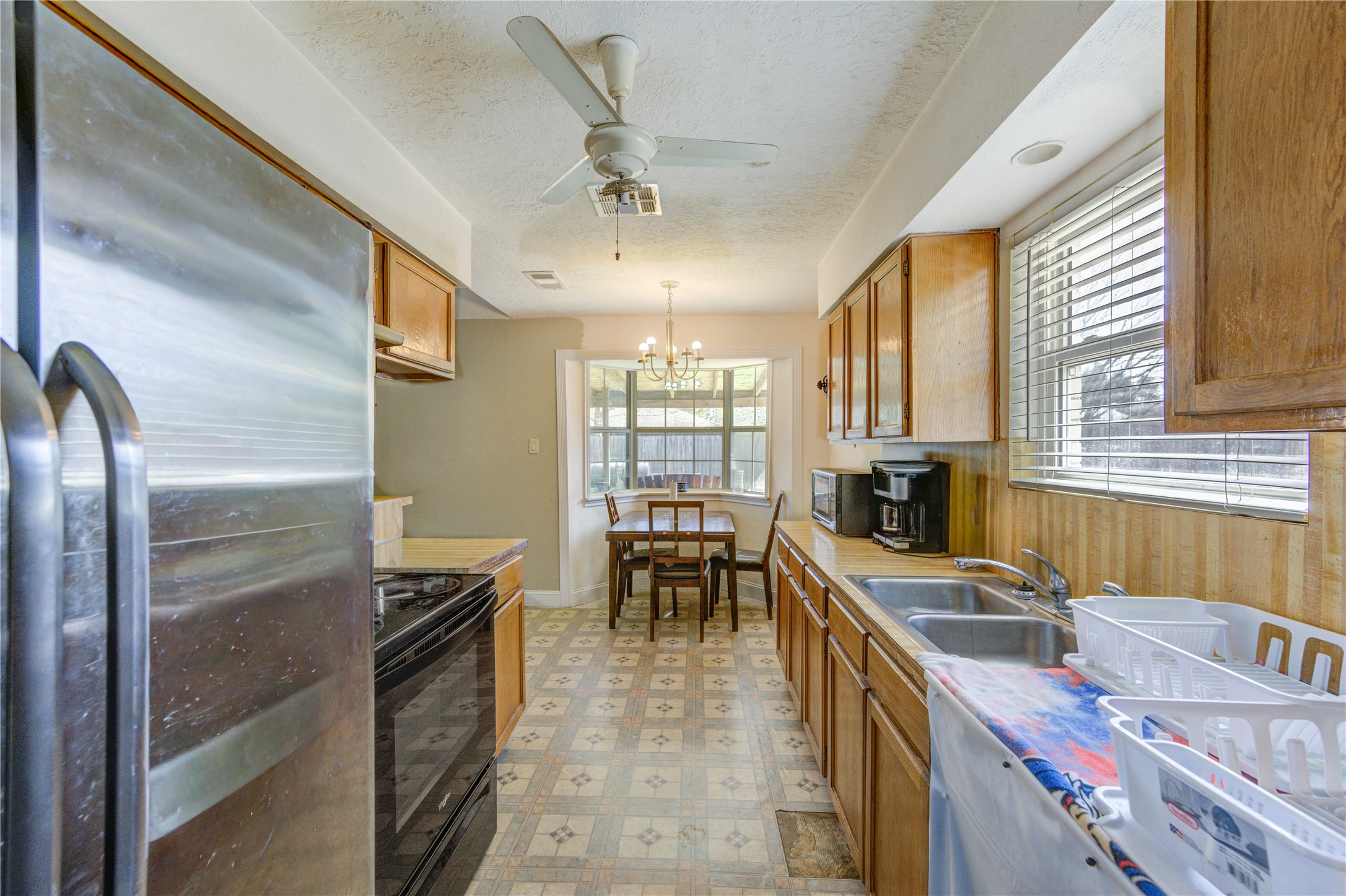 8610 Bluebonnet Street Highlands, TX 77562 - Photo 13 of 45 a kitchen with stainless steel appliances granite countertop a sink stove and refrigerator