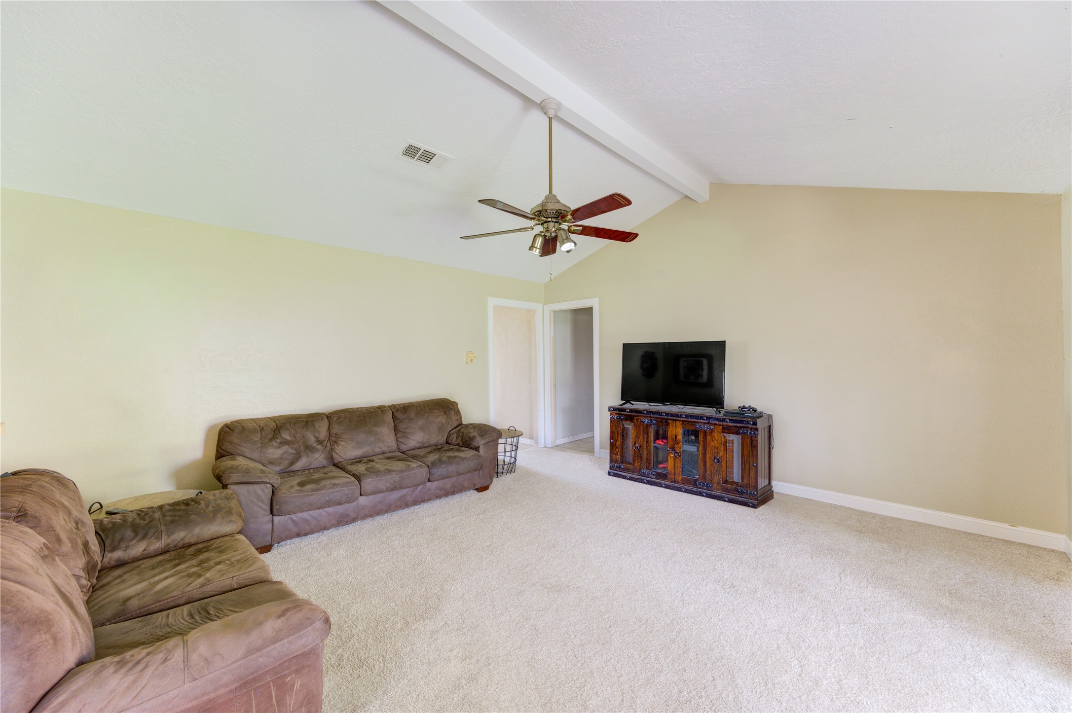 8610 Bluebonnet Street Highlands, TX 77562 - Photo 16 of 45 a living room with furniture and a flat screen tv
