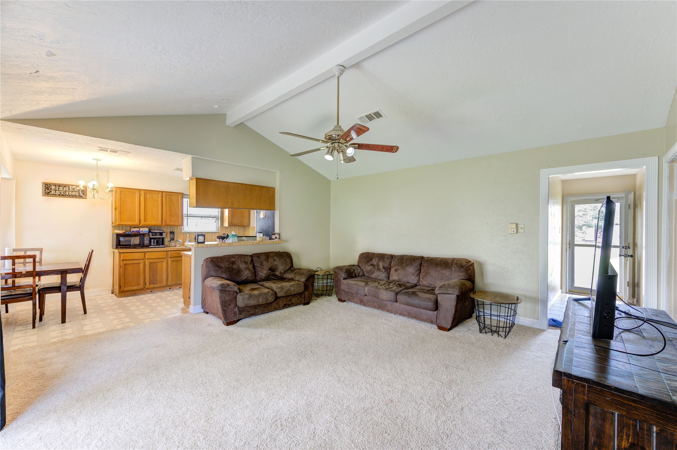 8610 Bluebonnet Street Highlands, TX 77562 - Photo 17 of 45 a living room with furniture kitchen view and a chandelier