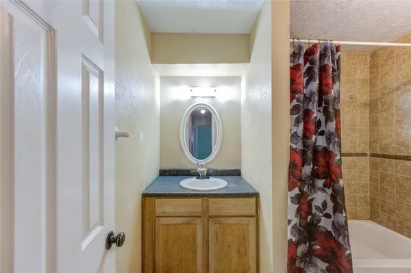 a bathroom with a mirror and a shower