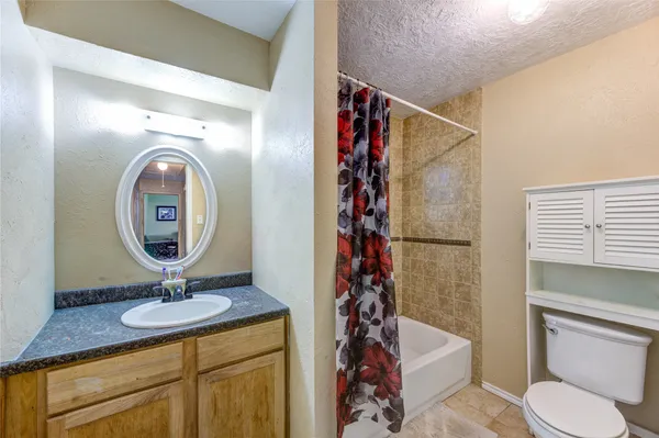 a bathroom with a toilet a sink and a mirror