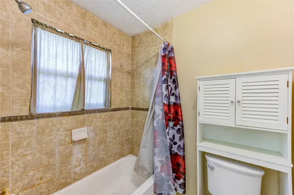 a bath room with a window and a bath tub