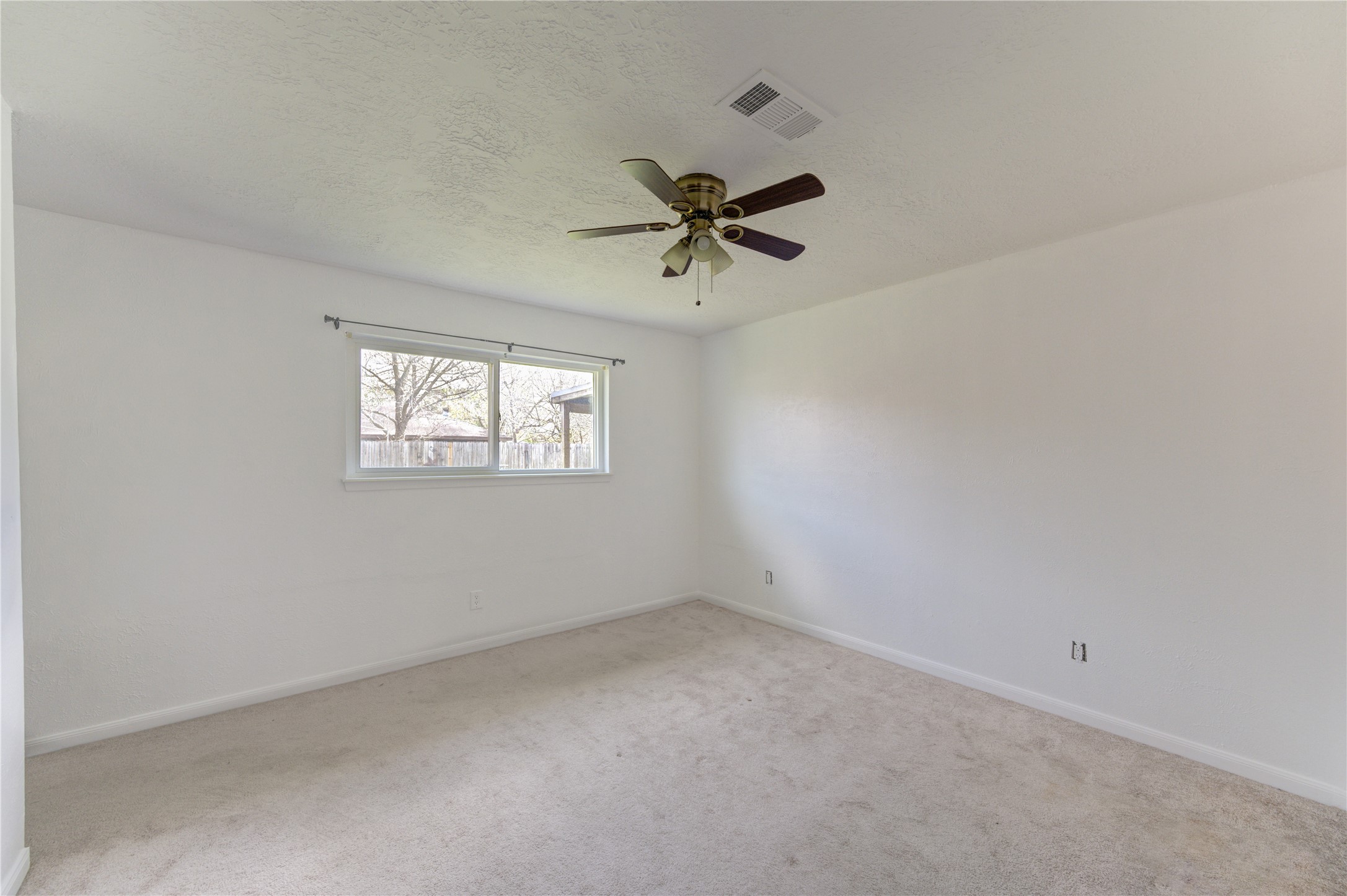 8610 Bluebonnet Street Highlands, TX 77562 - Photo 25 of 45 an empty room with windows and fan